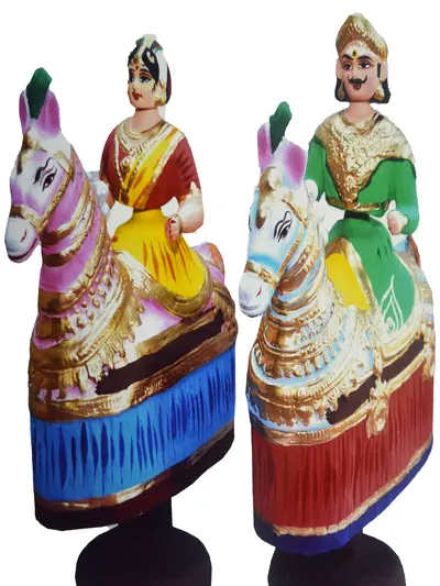 Two painted dolls of riders on white horses
