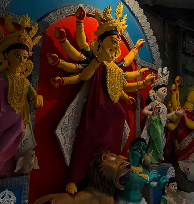 A richly decorated idol of Goddess Durga with many arms, a lion at her feet