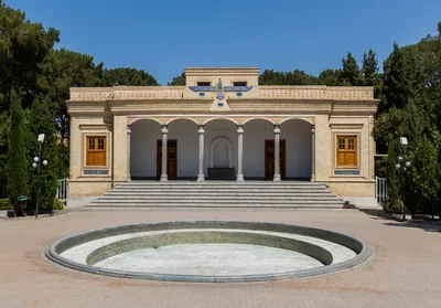 A Zoroastrian fire temple with the Faravahar symbol above its arches