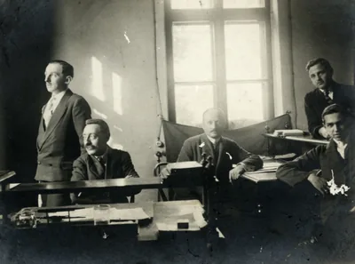 An old photo of men working at desks in an office
