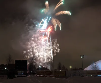 Fireworks bursting over a snowy town at night