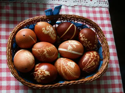 A basket of brown eggs with white leaf patterns