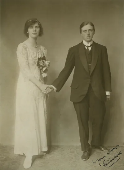 An old photo of a bride and groom holding hands