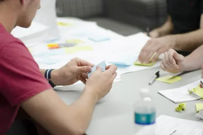 People sharing notes at a meeting table