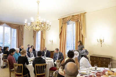 A room with chandeliers where guests gather for iftar