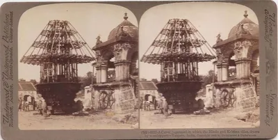 An old stereo photograph of a tall wooden temple chariot