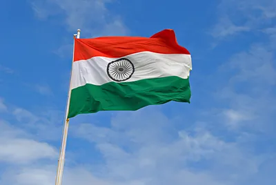 The Indian tricolour flying against a blue sky