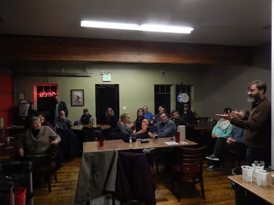 People sitting at tables in a restaurant room during a retirement party