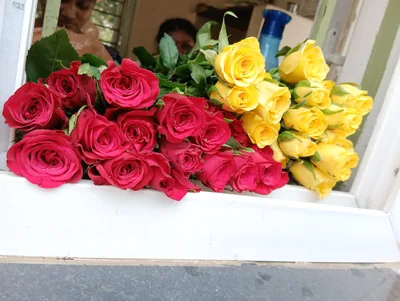 Red and yellow roses laid out at a flower stall