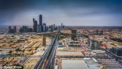 A wide view of tall towers and highways across a big city