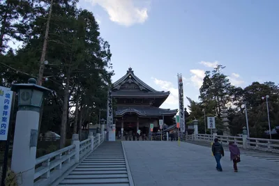 Stone steps leading up to a temple hall under a blue sky