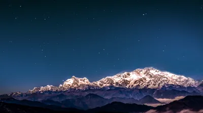 The snow peaks of Kanchenjunga under a starry night sky