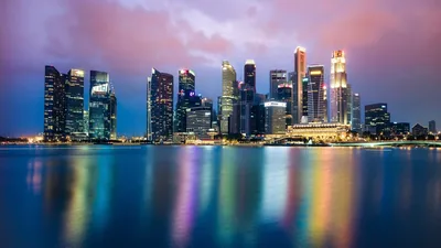 The city skyline reflected in the bay at dusk