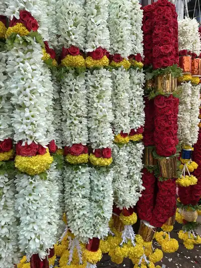 Hanging garlands of white jasmine with red and yellow flowers