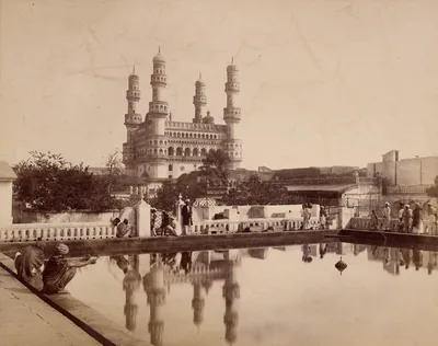 Old photo of the Charminar reflected in a pool of water