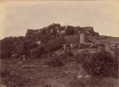Old photo of fort walls and towers on a rocky hill