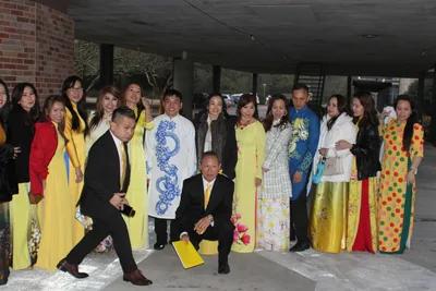 A group in colourful ao dai posing together at a Tet gathering