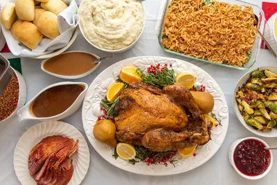 A roast turkey with mashed potatoes, gravy and side dishes