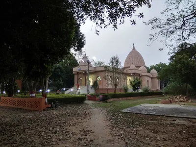 The white domed temple of the Ramakrishna Mission in Agartala among green trees