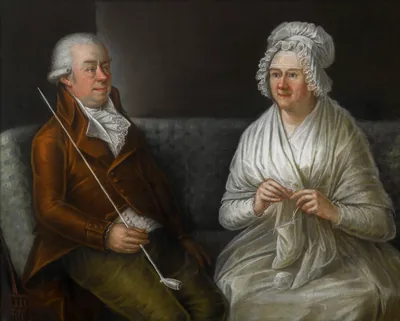 An old painting of an elderly couple sitting together