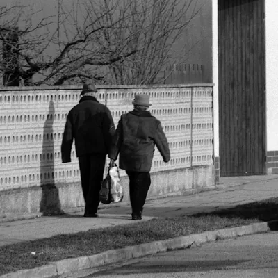 An older couple seen together in a quiet street