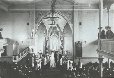 An old photo of a wedding at the altar of a grand church