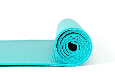 A rolled turquoise yoga mat on white