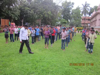 A large group doing yoga together on a green field