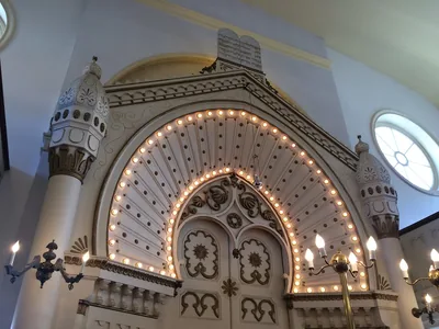 An ornate arch of lights over the ark in a synagogue